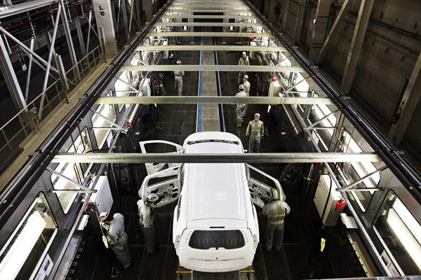 Water treatment for car industry - White car, doors opened, staff working.